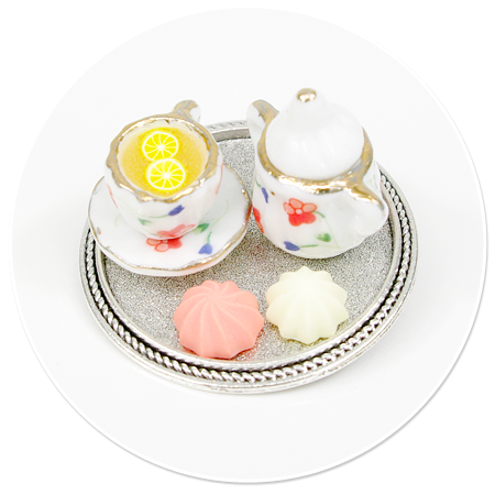 brooch of tray with tea and sweets